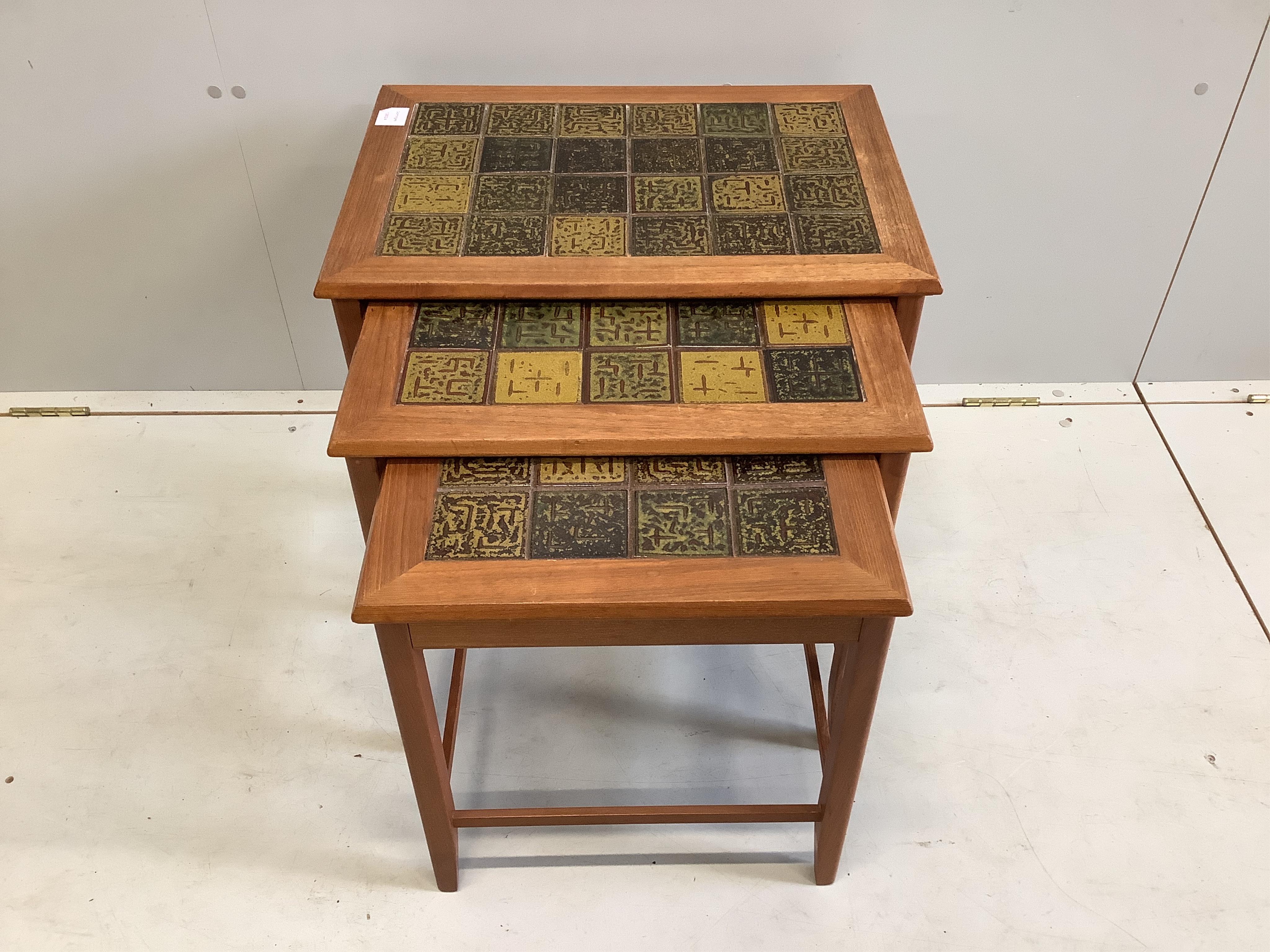 Trioh, a nest of three mid century Danish teak tile top tea tables, width 56cm, depth 41cm, height 48cm